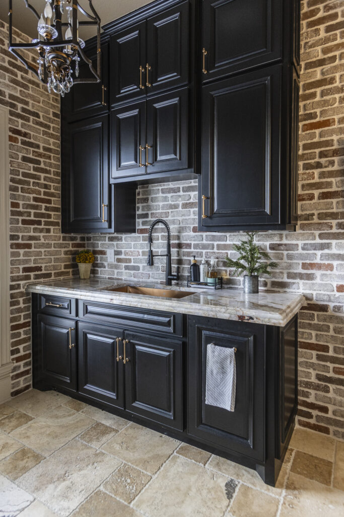 what is the 60-30-10 rule - image of black cabinets in kitchen over countertop and brick backsplash/wall